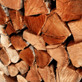 Close-up shot of dry Black Wattle firewood logs stacked for indoor fireplace heating