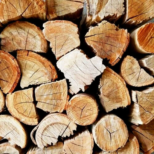Detailed close-up shot of dry Blue Gum braai and fireplace firewood logs stacked for heating.