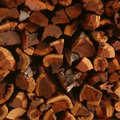 Close-up shot of heavy Namibian Mopane ironwood logs displaying dark chocolate-red grain