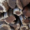 Close-up of dry Swarthaak logs with no bark showing dense grain and natural seasoning